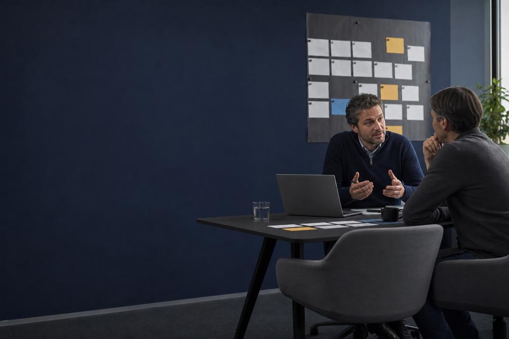 Illustratieve cloud consultant en beslisser die huidige systemen, cloudopties, kosten, risico’s en roadmap vergelijken